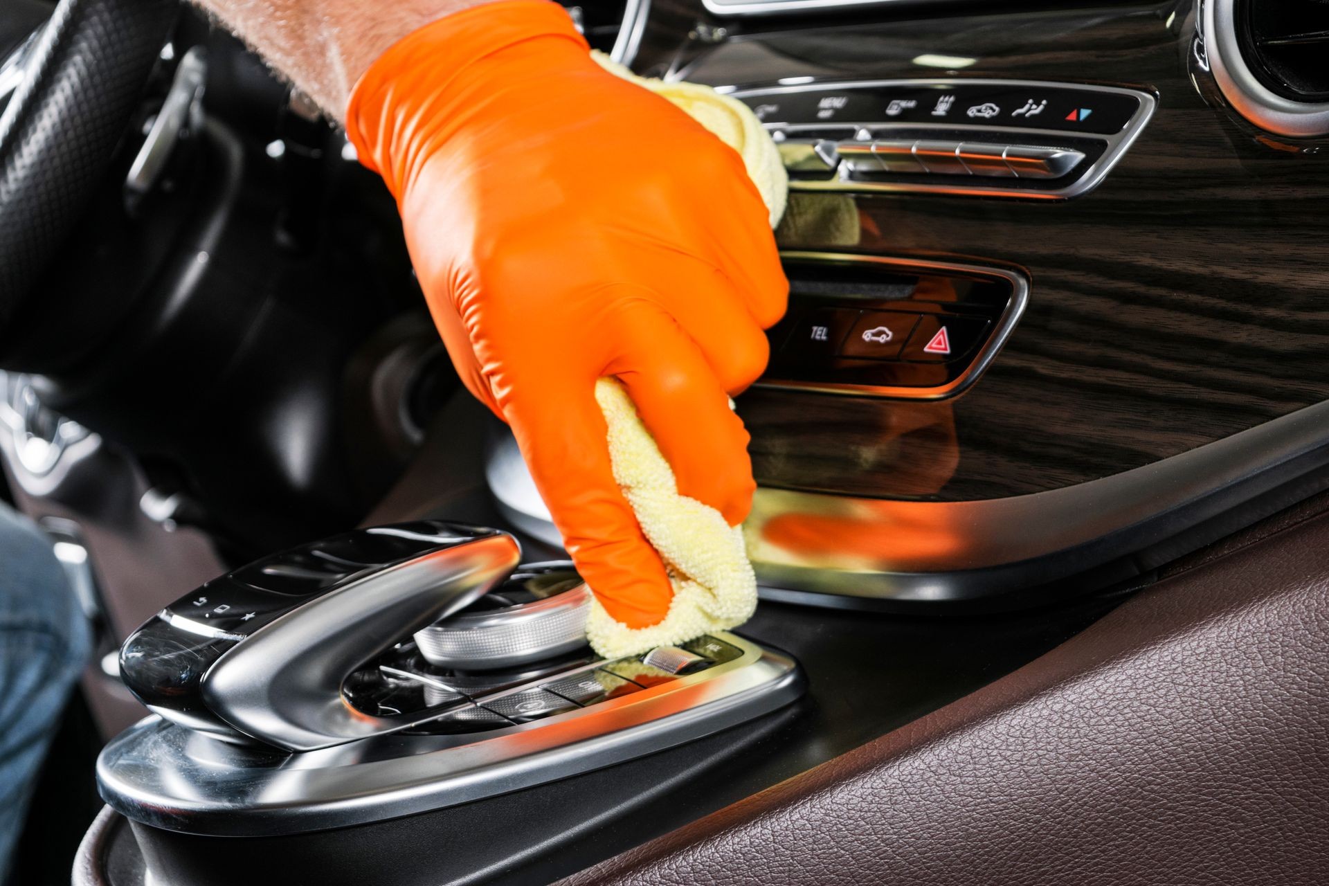 A man cleaning car with microfiber cloth. Car detailing. Selective focus. Car detailing. Cleaning with sponge. Worker cleaning. Microfiber and cleaning solution to clean. 